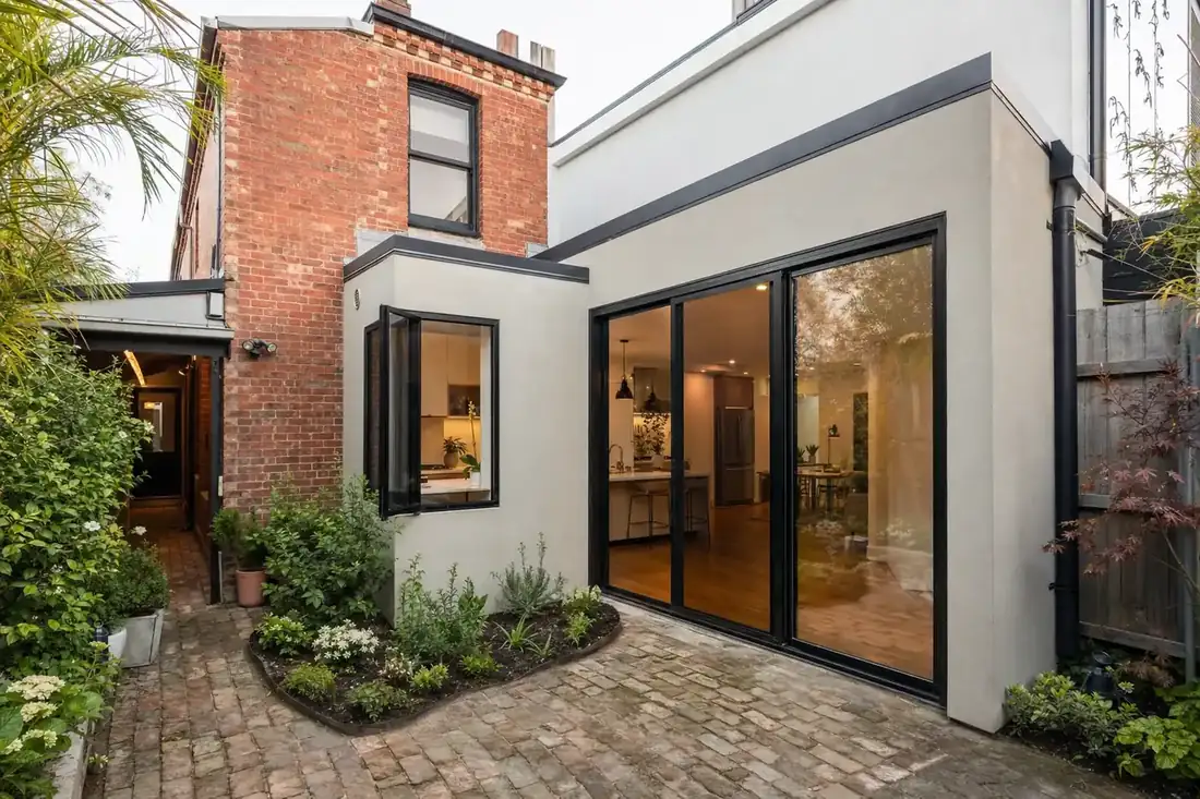 Black aluminium windows and sliding doors on the rear extension of a Melbourne brick terrace